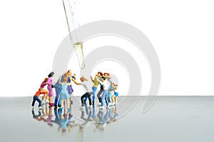 Miniature people toy figure photography. Group of people jostling for vaccine