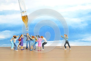 Miniature people toy figure photography. Group of people jostling for vaccine