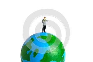 Miniature people toy figure photography. International or National reading day. A men student standing above earth globe while