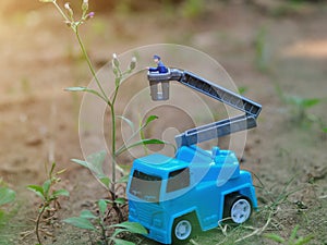 Miniature People and toys: Worker at the construction with chery picker truck background