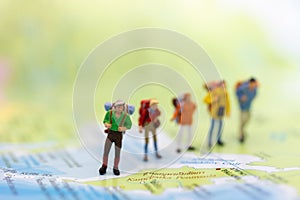 Miniature people : traveler walking on the map Thai language. Used to travel to destinations on travel business background concept