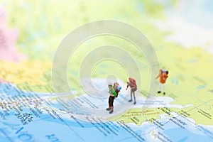 Miniature people : traveler walking on the map Thai language. Used to travel to destinations on travel business background concept