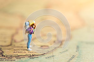 Miniature people : traveler walking on the map. Used to travel to destinations on travel business background concept.