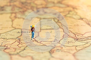 Miniature people : traveler walking on the map. Used to travel to destinations on travel business background concept