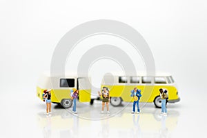 Miniature people: travelers with backpack standing on world map travel by van. Image use for travel business concept
