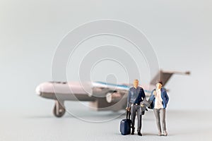 Miniature people, travelers embarks on a delightful vacation, gleefully boarding a tiny airplane