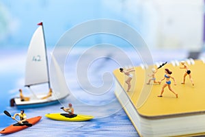 Miniature people : Travelers have activities on the beach and swimming on blue ocean. Image use for sport, vacation ,travel