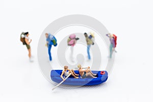 Miniature people : Travelers with paddle boat with group travelers for background. Image use for activities, travel business conce