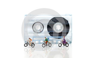 Miniature people : Travelers riding bicycle with Audio cassette