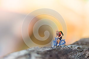 Miniature people : Travelers riding bicycle on the road using as background traveling business concepts