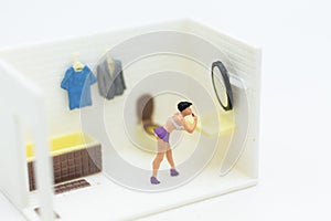 Miniature people : Women make up face in the toilet, daily routine, personal errands in the bathroom