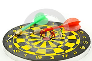 Miniature people : worker digging on the target on dart board, c