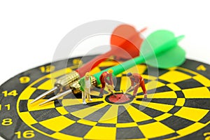 Miniature people : worker digging on the target on dart board, c