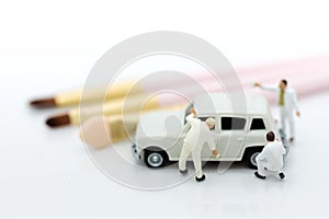 Miniature people : Worker make up the car. Image use for cleaning and maintenance, business autocar concept