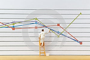 Miniature people : Worker painting business graph on white background