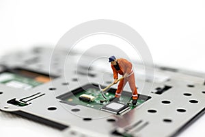 Miniature people: Worker repairing circuit board ,electronics repair. Use image for support and maintenance business