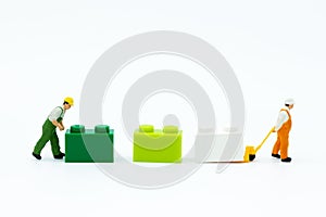 Miniature people: Worker use pallet truck with the colorful boxes. Image use for background business of warehouse concept