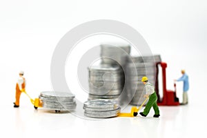 Miniature people: Worker use pallet truck with stack of coins. Image use for background business concept