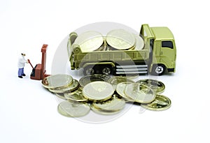 Miniature People : The worker in white cloth with lifting to transfer money in the in golden truck use as investment and success