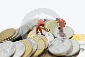 Miniature people: Worker working on stack of coins, income from work. Image use for business concept