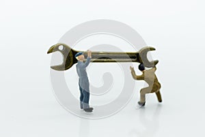 Miniature people: Workers are carrying a wrench. Image use for business industry concept