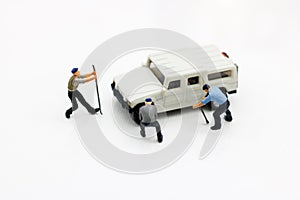 Miniature people: Workers fixing car. car service, repair, maintenance concept