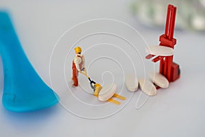 Miniature people: Workers help to moving drug. Image use for health check concept