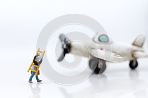 Miniature people: Workers prepare equipment for maintenance of the plane. Image use for treatment, business concept