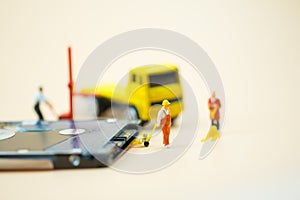 Miniature people: Workers pulling a pallet truck with circuit board moving for sent to repair