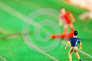 Miniature plastic figure model of soccer player.