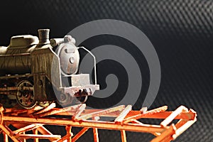 The miniature plastic model railroad on bridge.