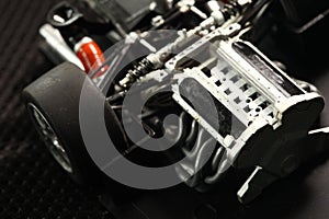 Miniature plastic model sport car engine part.