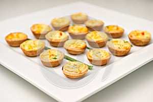 Miniature quiches on a white plate