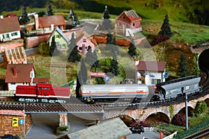 Miniature railway model with model freight train on a mountains ambientation. Toy Train