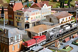 Miniature railway model with trains. Toy Train with wagons at Railway Station in a city