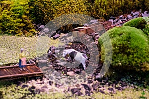 Miniature of realistic rural countryside landscape with a wooden windmill and people