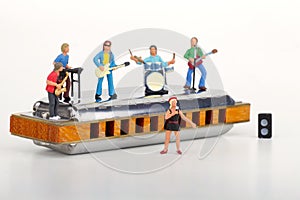 Miniature of a rock band playing on the harmonica