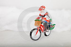 Miniature Santa Claus on bike