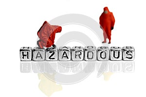 Miniature scale model team in chemical suits with the word hazardous