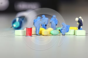 Miniature scientist at work with Medicine pills