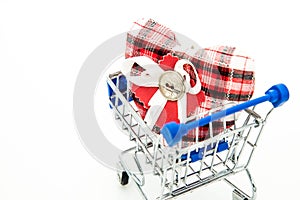 Miniature shopping cart with red heart inside closeup