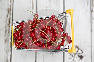 Miniature shopping cart with redcurrants