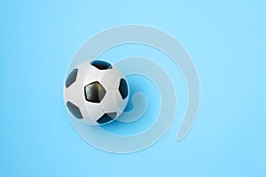 Miniature soccer ball on a blue background. World championship. Physical development of the child. How much does health cost?