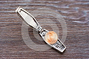 Miniature Steel Coffin with a Penny on Wooden Background