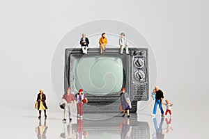 Miniature television and miniature people.