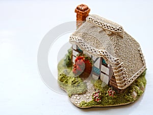 Miniature thatched cottage home in quaint english village