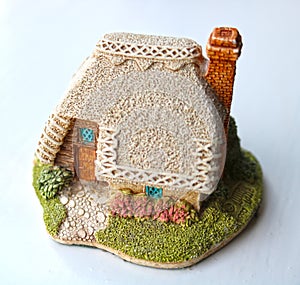 Miniature thatched cottage home in quaint english village