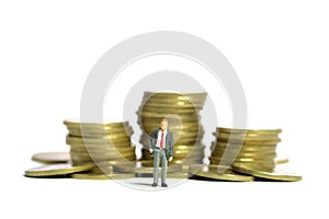 A businessman standing in front of coin money pile. Isolated on a white background