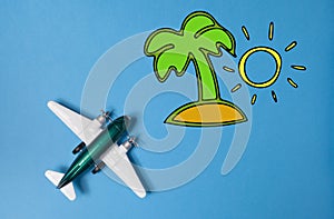 Miniature toy airplane and summer island draw on blue