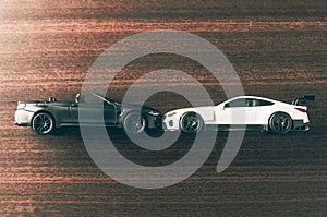 Miniature toy cars on wooden background, side view. Motor auto insurance concept